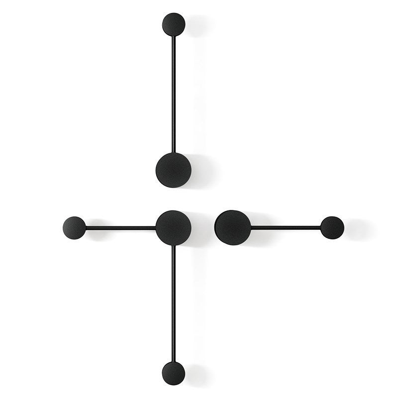 Modern wall clock with black circular design on a white background