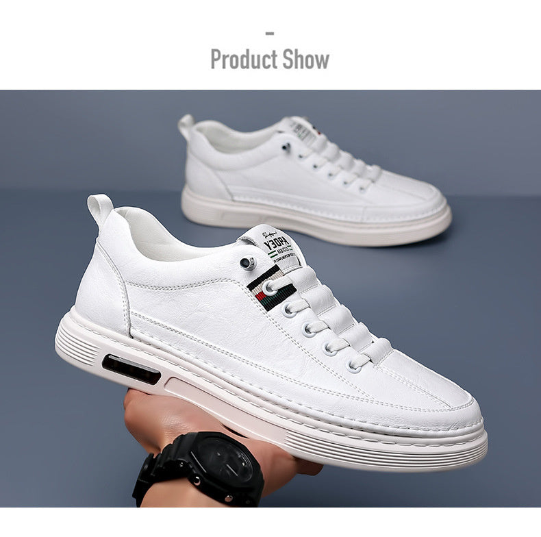 White sneakers held by a person against a gray background