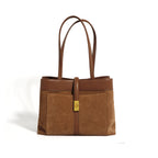 Brown handbag with a gold clasp on a white background