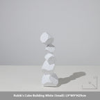 Stack of white geometric blocks on a light gray background