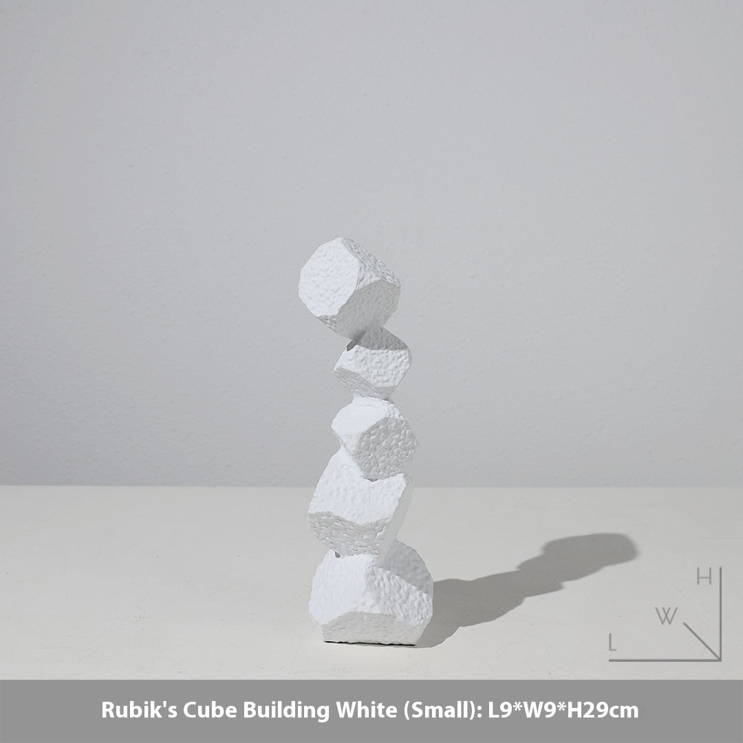 Stack of white geometric blocks on a light gray background