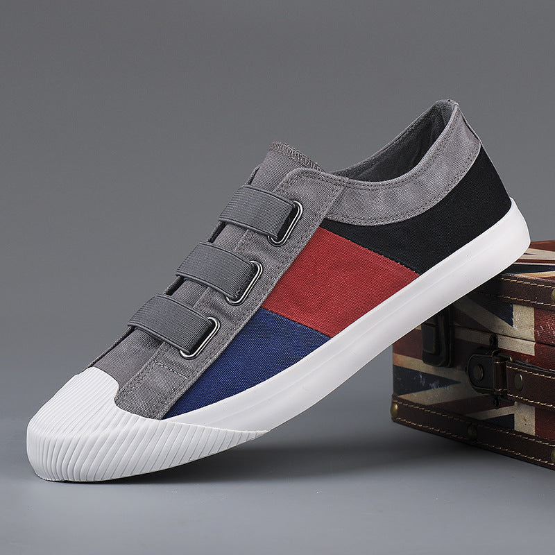 Multicolored sneaker with gray, red, and blue design on a gray background