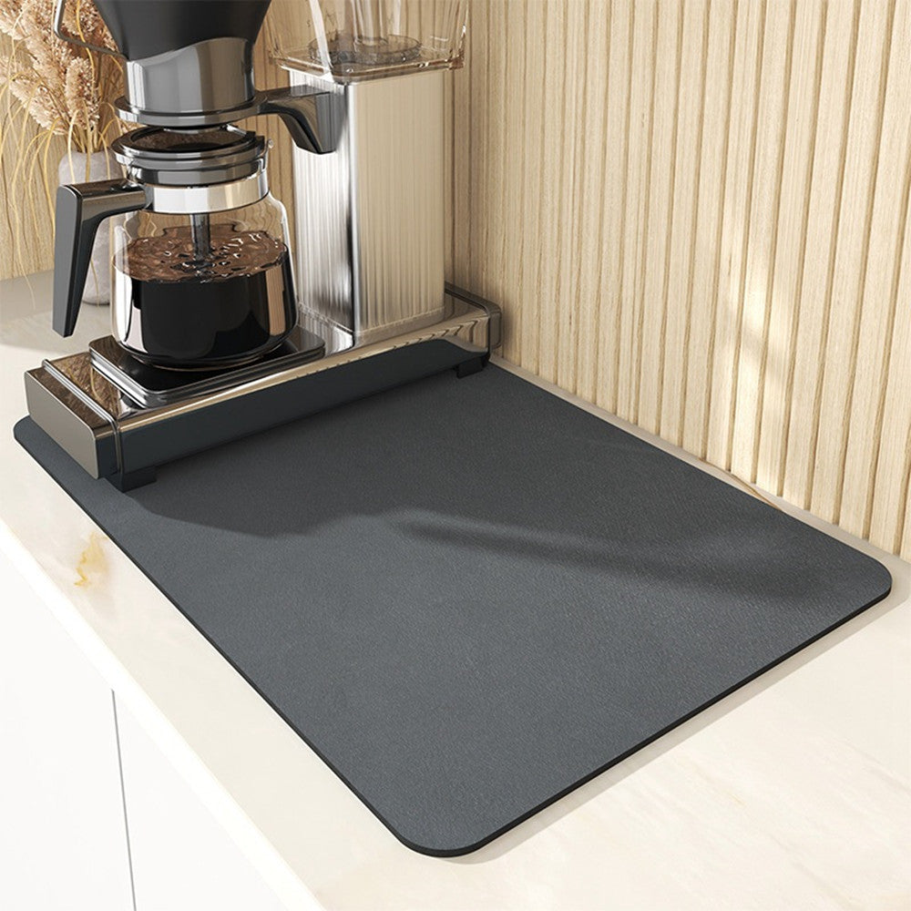 Gray mat on a kitchen counter with a coffee maker in the background