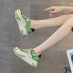 sandals worn by a person sitting on a chair with a gray background