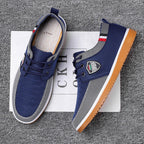 Pair of blue sneakers with a brand logo on a textured surface