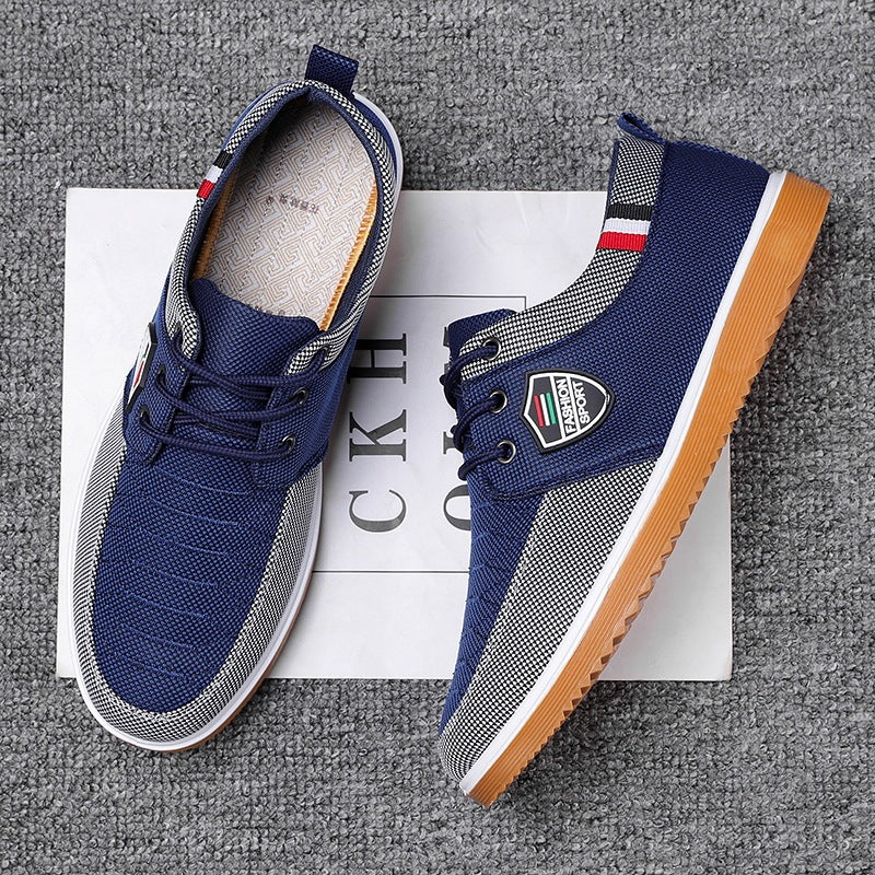 Pair of blue sneakers with a brand logo on a textured surface