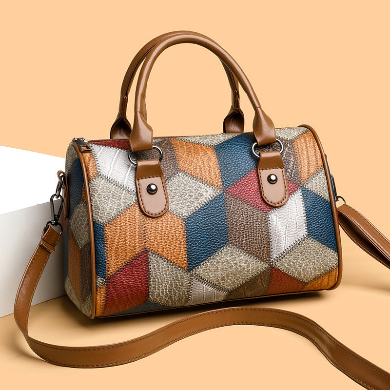 Multicolored patchwork handbag with brown leather accents on a beige background