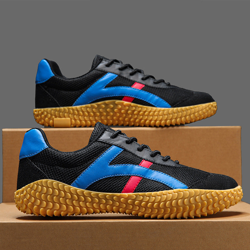 Black and blue sneakers with yellow soles on a cardboard box