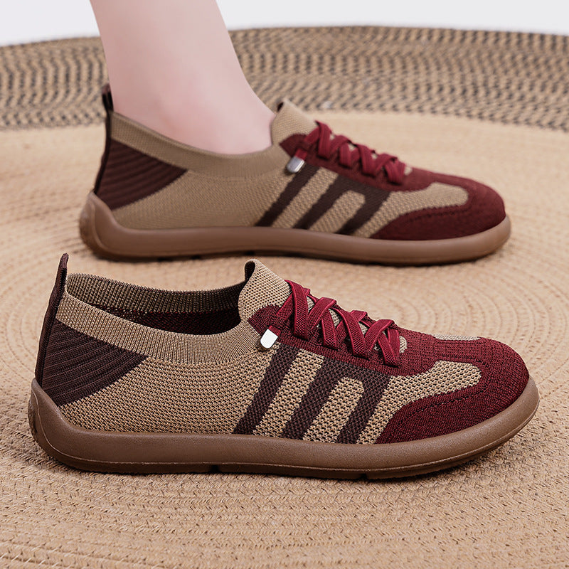 Brown and maroon sneakers on a textured surface