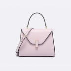 Pink handbag with a strap on a light gray background