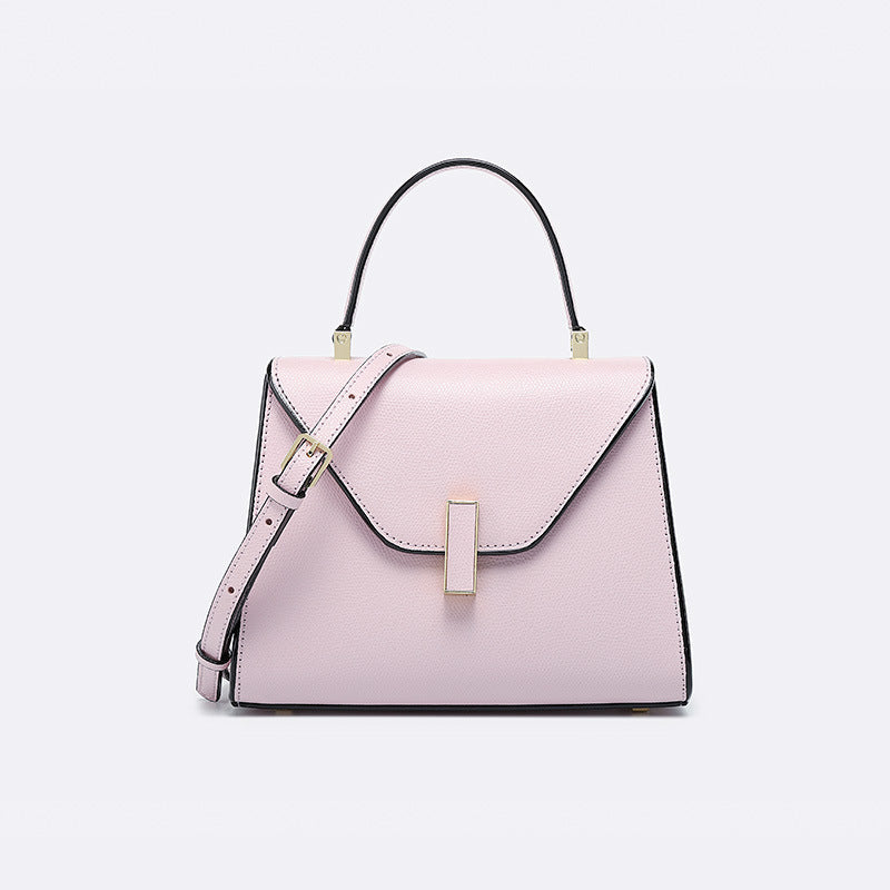 Pink handbag with a strap on a light gray background