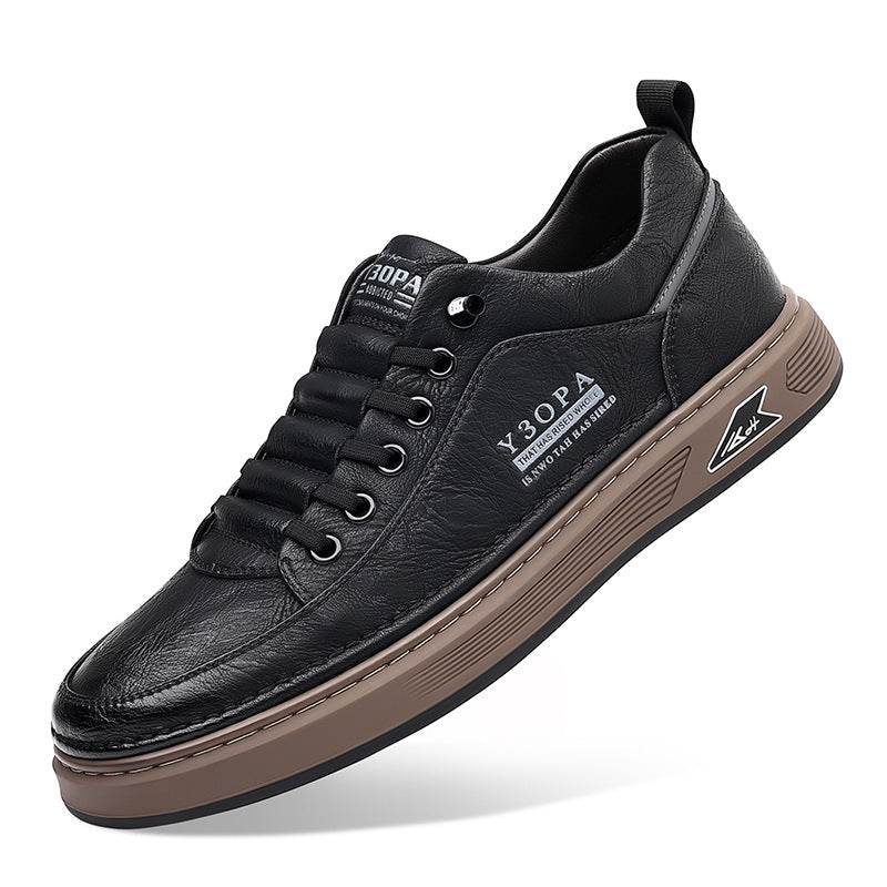 Black leather sneaker with brown sole on a white background