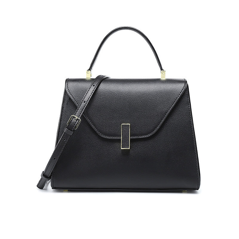 Black handbag with a strap on a white background