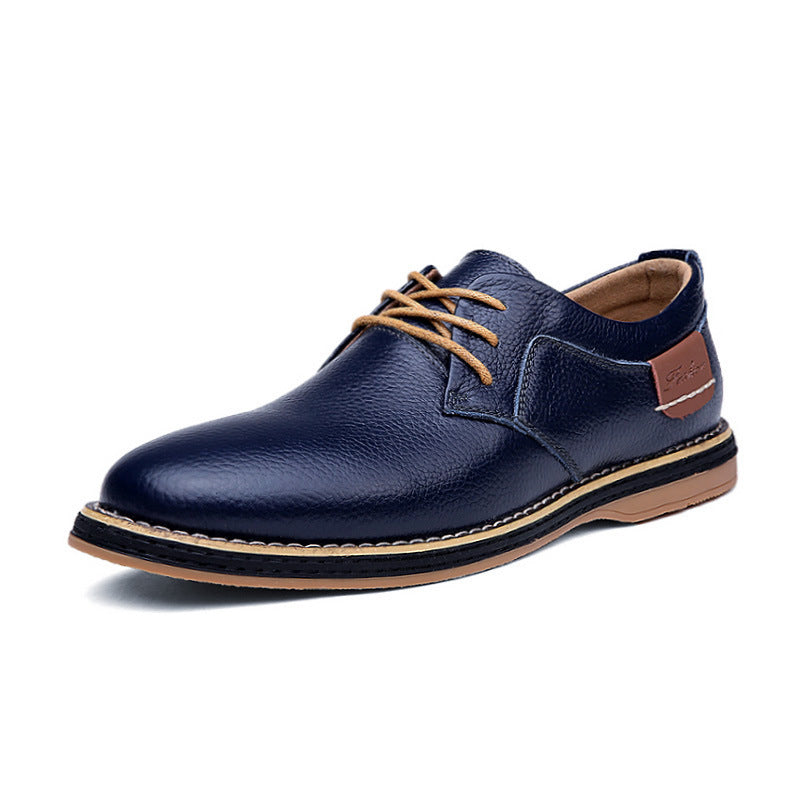 Navy blue leather shoe with brown laces and sole on a white background