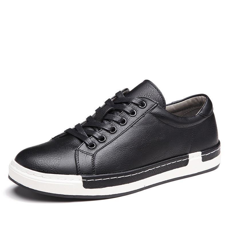 Black leather sneaker with white sole on a white background