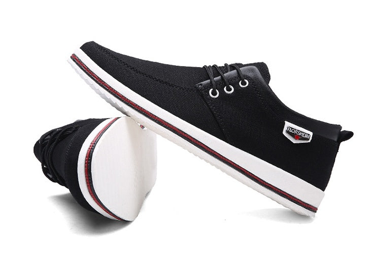 Black casual shoes with white soles on a white background
