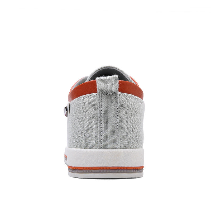 Gray sneaker with orange accents on a white background