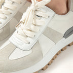 Close-up of a pair of light gray and white sneakers with white laces.