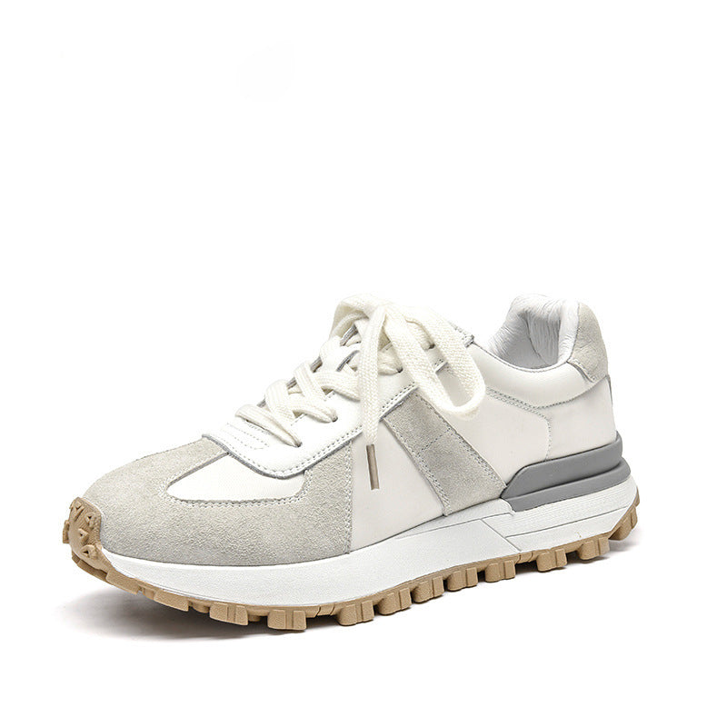 White and gray sneaker with a brown sole on a white background