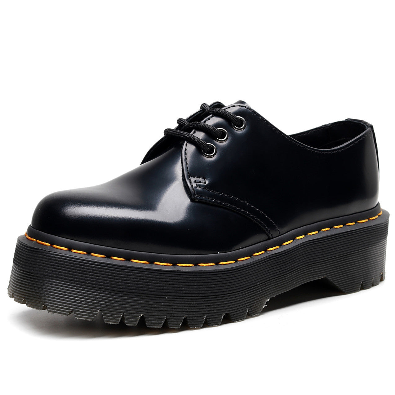 Black leather shoe with yellow stitching on a white background