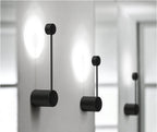 Two black wall lamp on a white wall with a blurred background