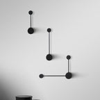 Modern black wall lamp with geometric design on a white background