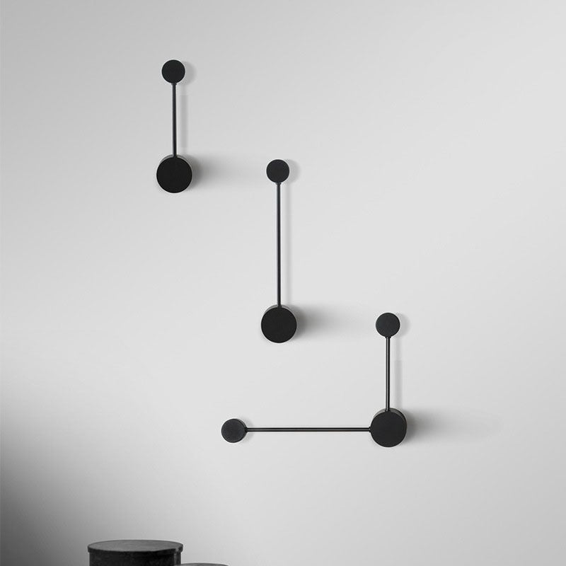 Modern black wall lamp with geometric design on a white background