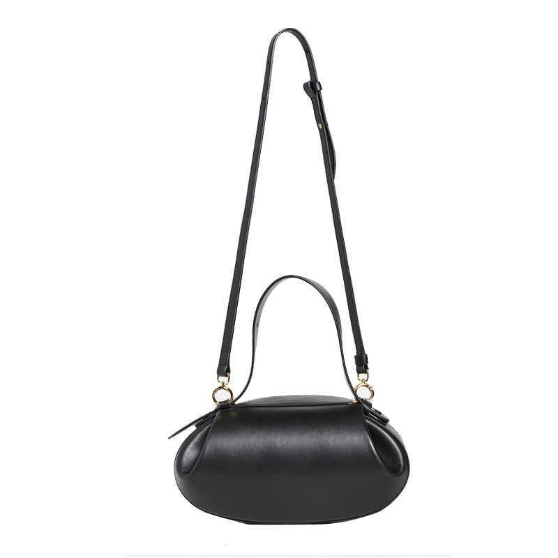 Black handbag with a strap on a white background