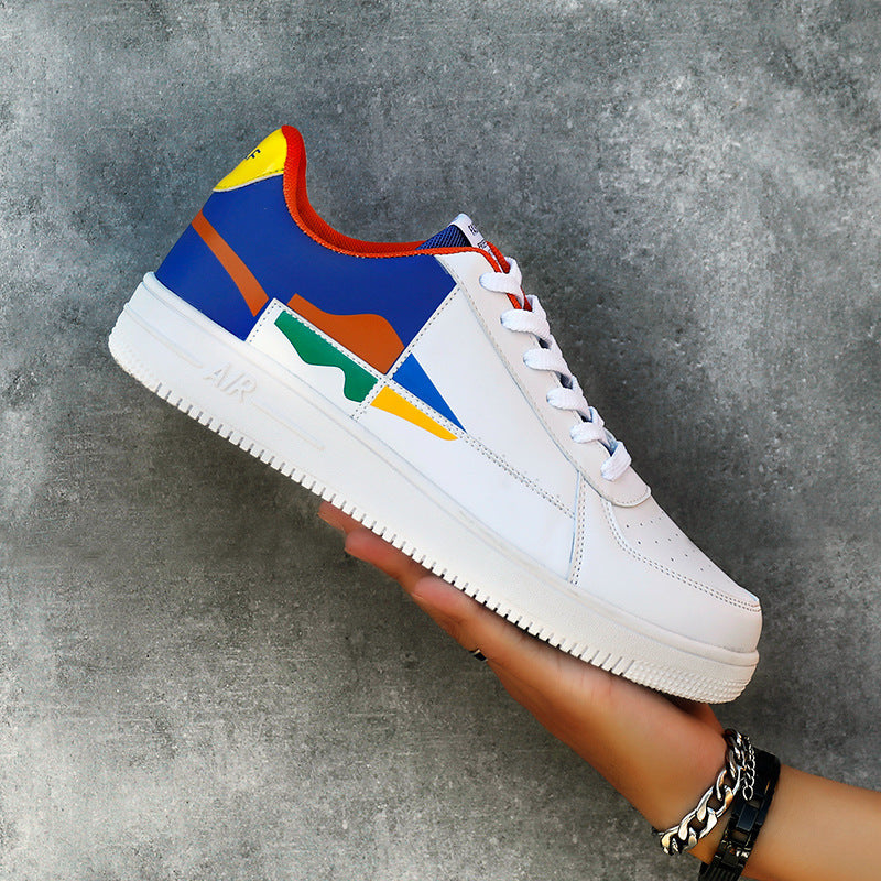 Colorful sneaker with a white sole held against a gray background