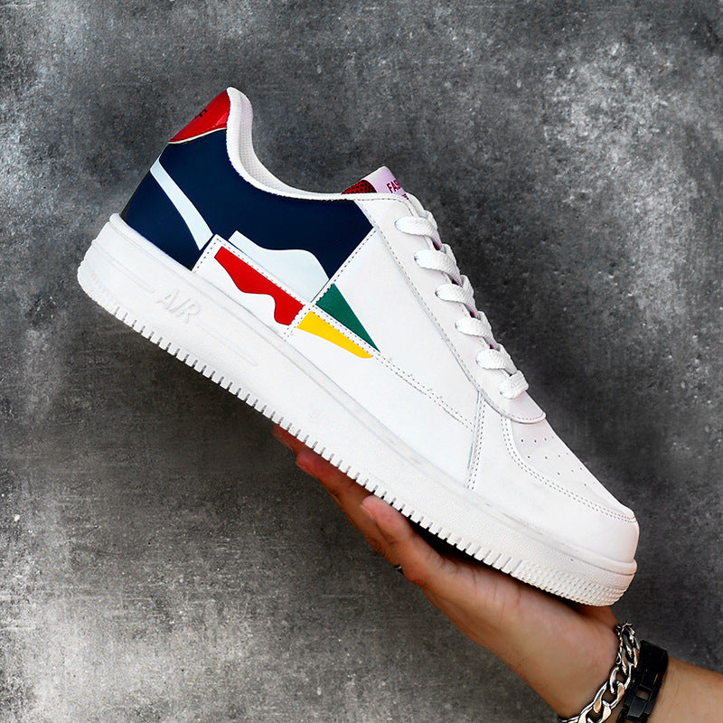 White sneaker with colorful design held by a hand against a gray background