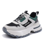 Sneaker with black, white, and green color scheme on a white background