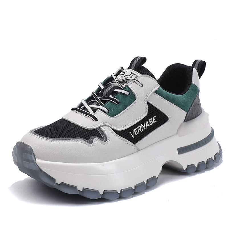 Sneaker with black, white, and green color scheme on a white background