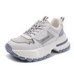 White and gray sneaker with thick sole on a white background