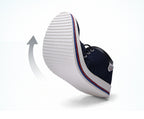 Navy blue sneaker with white sole on a white background
