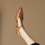 Tan leather sandal on a beige background