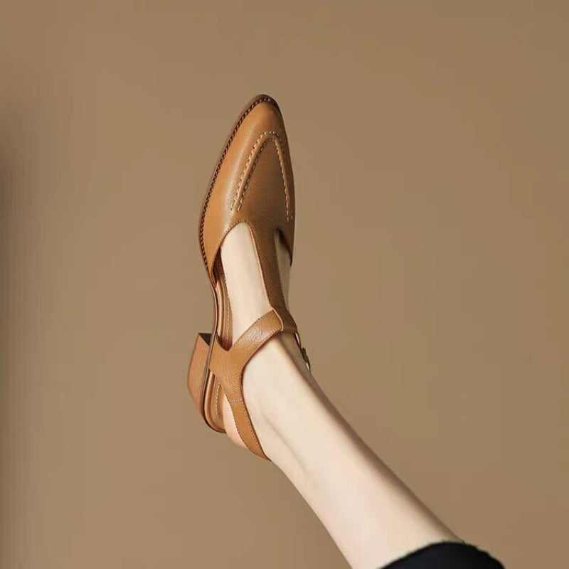 Tan leather sandal on a beige background