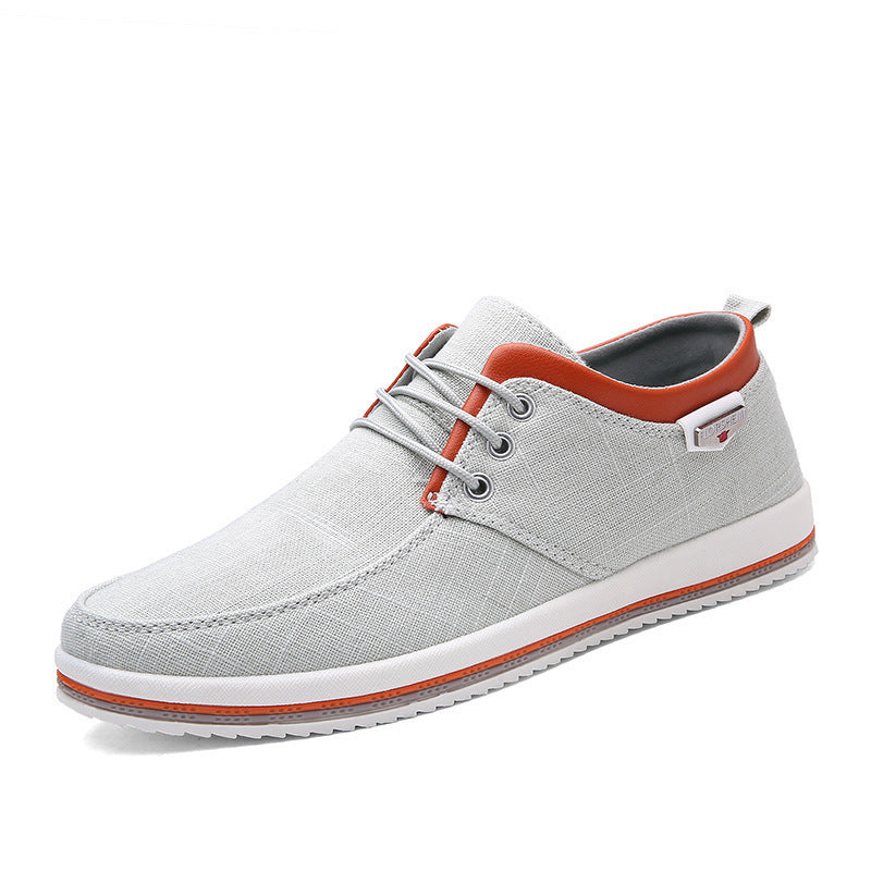 Gray casual shoe with orange accents on a white background