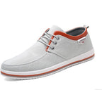 Gray casual shoe with orange accents on a white background