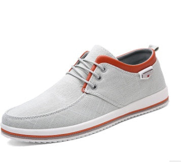 Gray casual shoe with orange accents on a white background