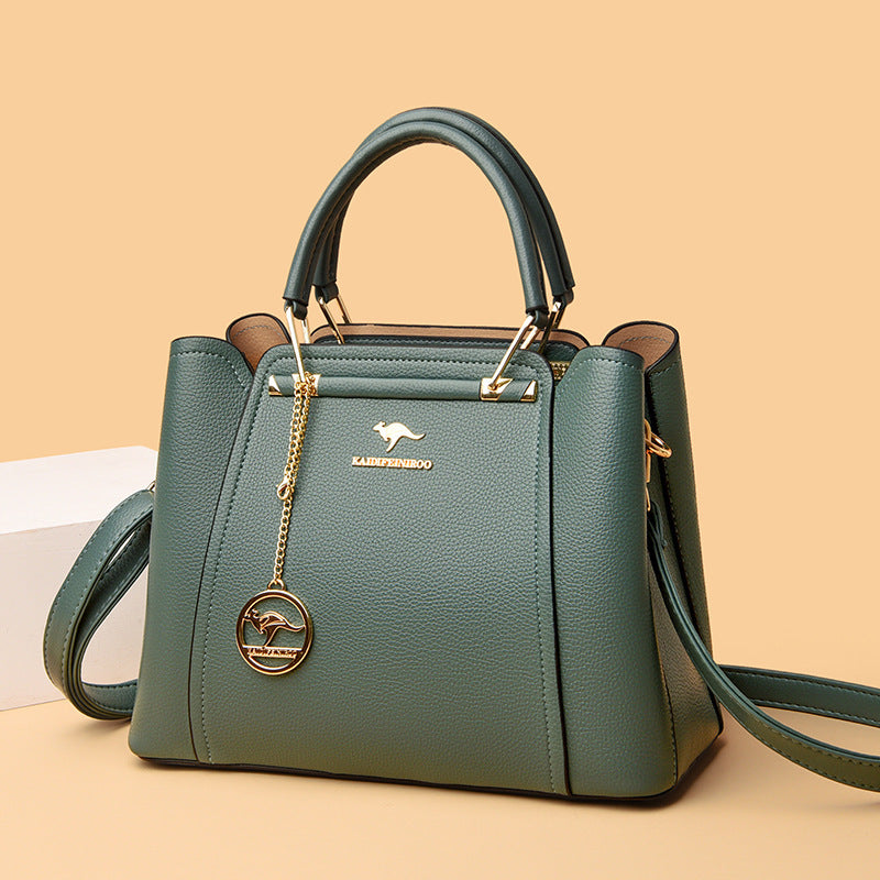 Green handbag with a brand logo on a beige background