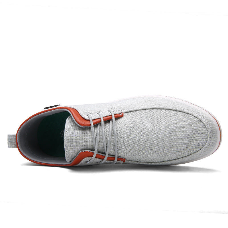 Gray sneaker with orange accents on a white background