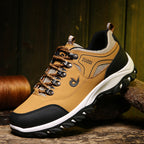 Brown and black hiking shoe with 'Zuodi' branding on a wooden surface.