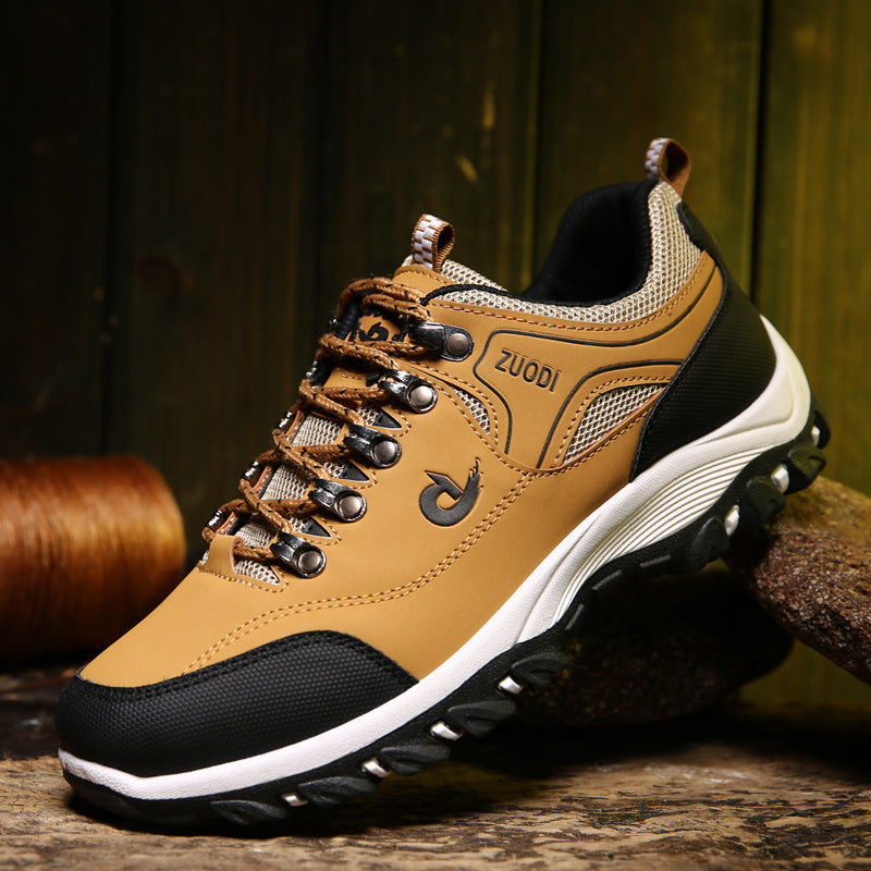 Brown and black hiking shoe with 'Zuodi' branding on a wooden surface.