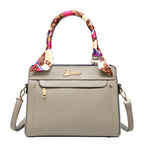 Gray handbag with a colorful handle on a white background