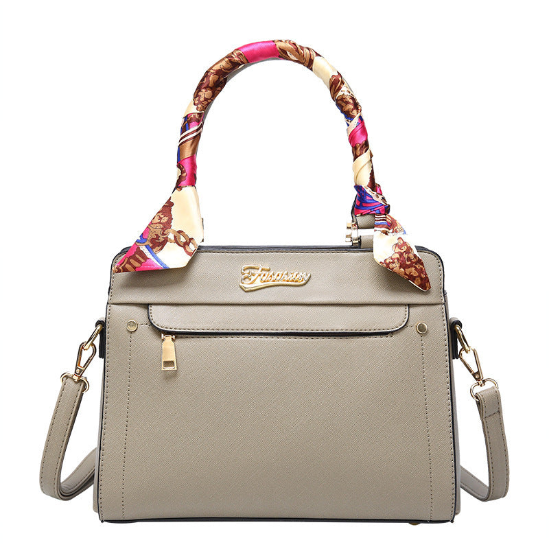 Gray handbag with a colorful handle on a white background
