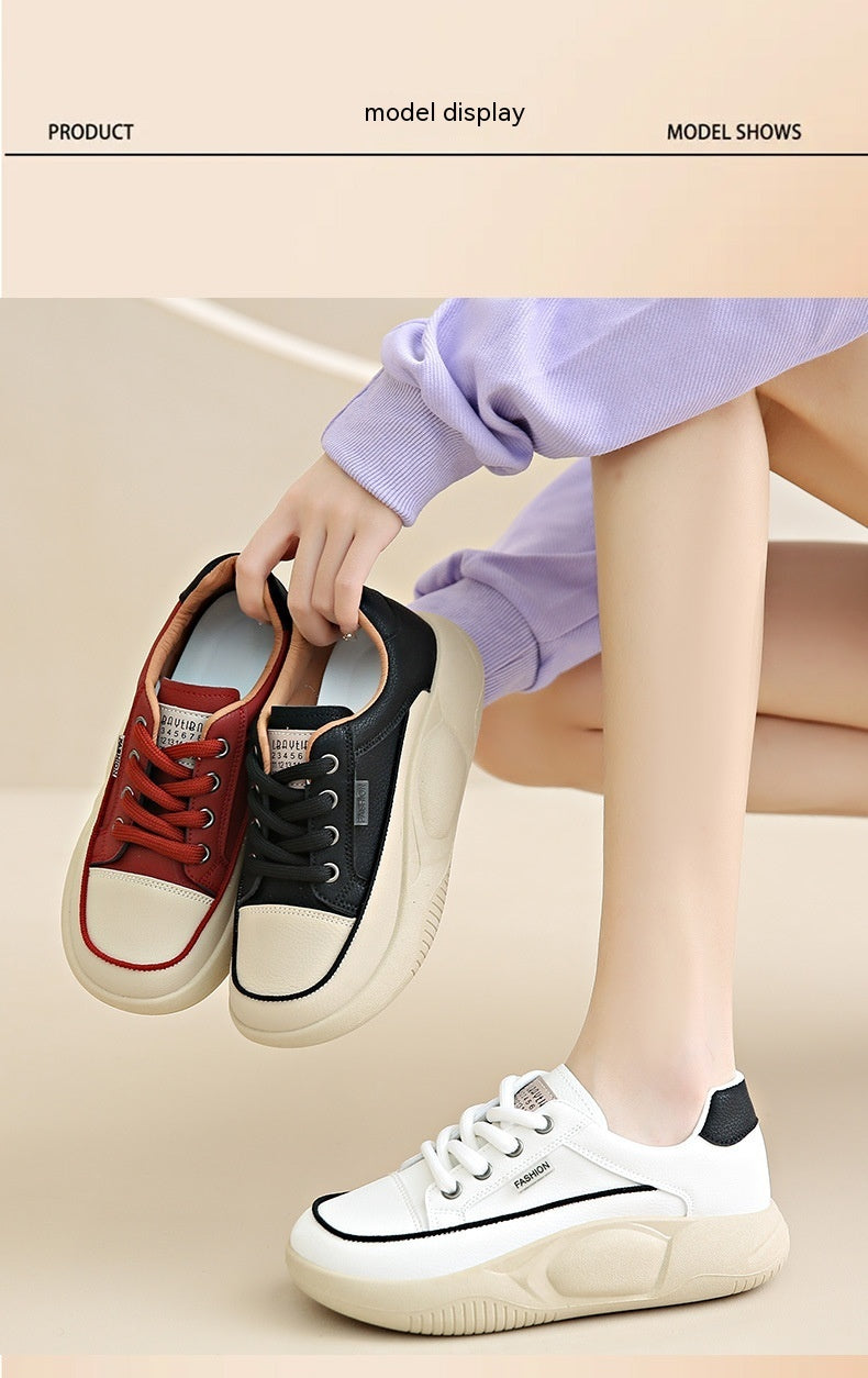 Person holding two sneakers with a focus on a white sneaker.