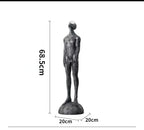 Statue of a person with dimensions labeled on a white background