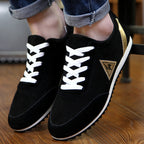 Black sneakers with white laces on a wooden floor