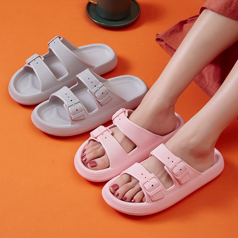Pink sandals worn on feet with orange background