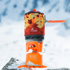 Orange camping stove with geometric pattern on a snowy background